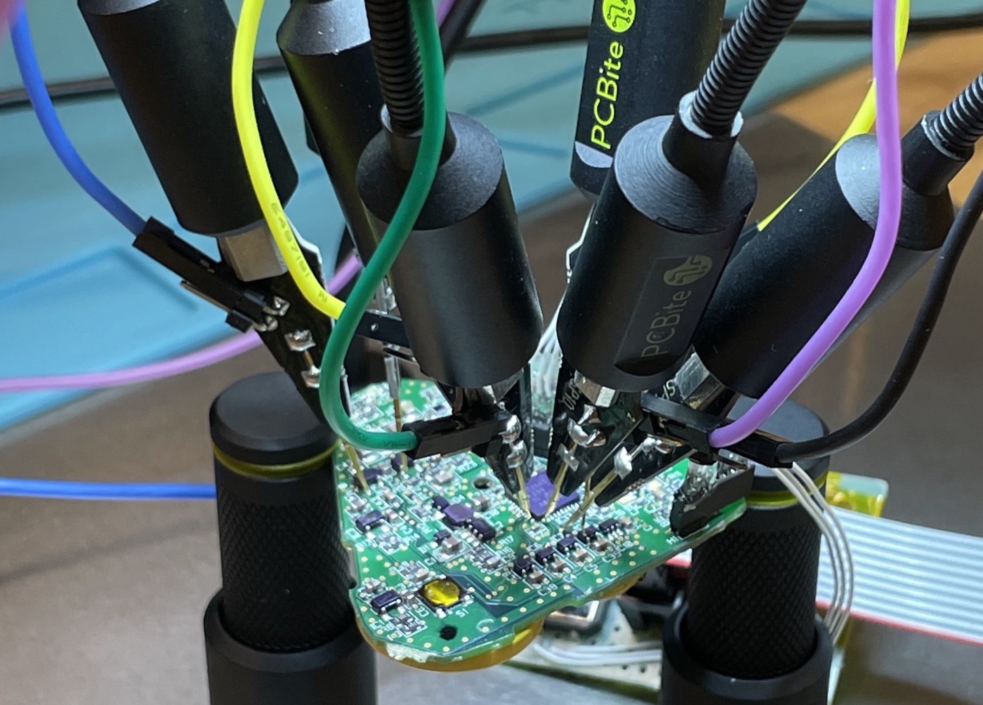 Prototype circuit board held under PCBite test probes
