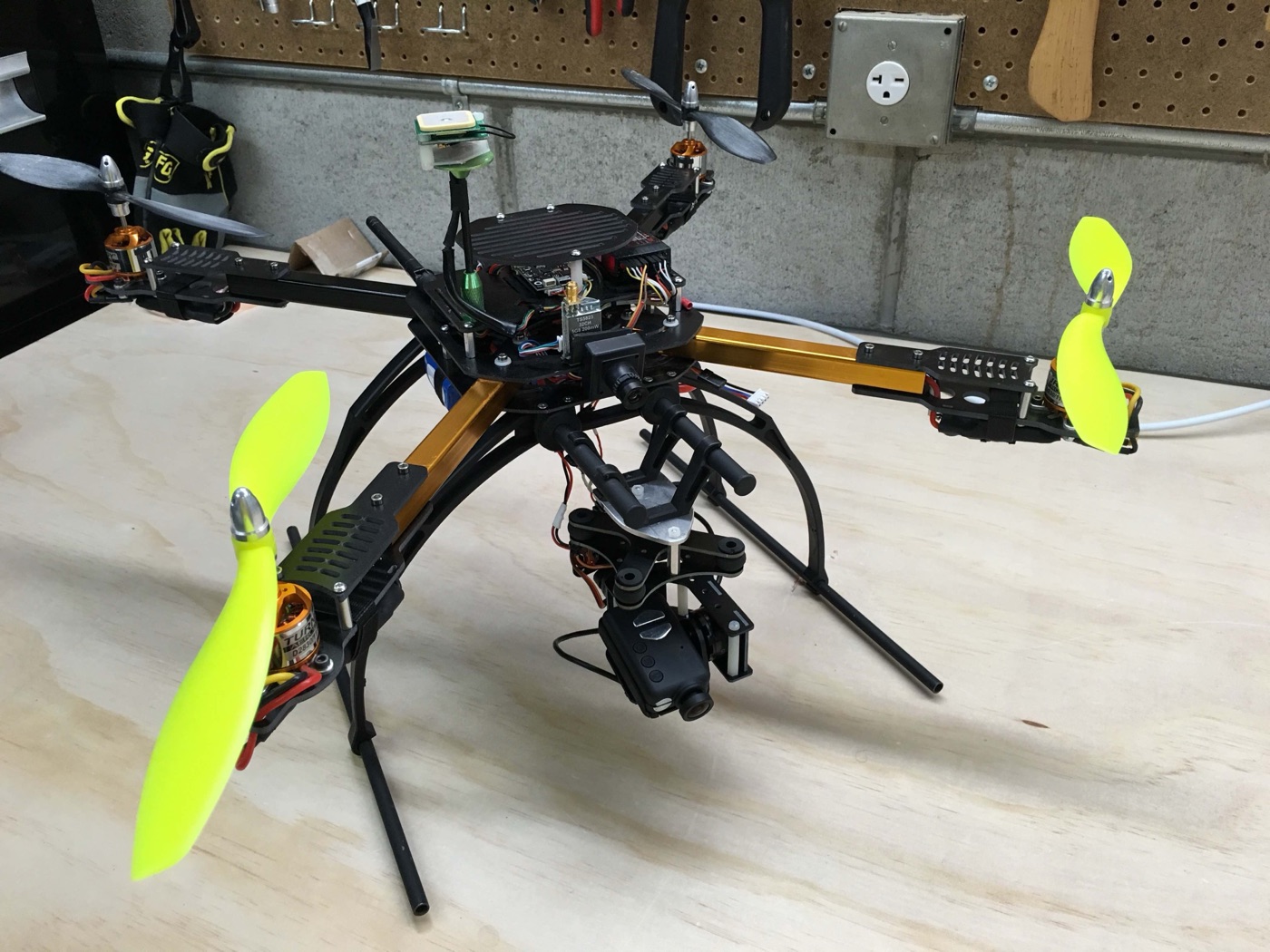 Custom quadcopter with camera gimbal on a workbench